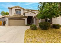 Charming two-story home featuring a spacious three-car garage and manicured landscaping at 3663 S Soho Ln, Chandler, AZ 85286