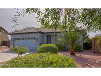 Charming single-story home with desert landscaping, featuring a two-car garage and covered entrance at 522 S 122Nd Ln, Avondale, AZ 85323