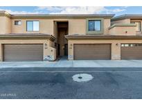 View of a well-maintained townhouse complex with private garages and neutral stucco facade at 705 W Queen Creek Rd # 1220, Chandler, AZ 85248