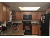 Traditional kitchen featuring wood cabinets, black appliances, and ample counter space at 925 S Longmore -- # 201, Mesa, AZ 85202