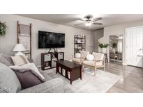 Comfortable living room with a ceiling fan, modern furniture, and neutral decor at 1257 N 47Th Pl, Phoenix, AZ 85008