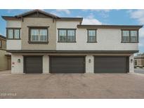 Attractive three-story townhome featuring private garages and tasteful exterior color palette at 14870 W Encanto Blvd # 2069, Goodyear, AZ 85395