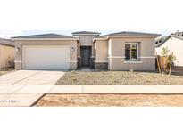 Charming single-Gathering home with a two-car garage and desert landscaping at 18166 E Colt Dr, Queen Creek, AZ 85142