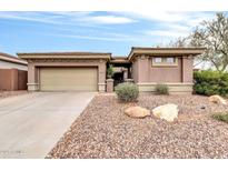 A single-story home with a two-car garage and desert landscaping at 2404 W Muirfield Dr, Anthem, AZ 85086