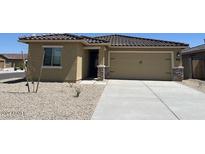 Charming single-story home with a neutral color palette, tile roof, and a two-car garage at 24611 W St Catherine Ave, Buckeye, AZ 85326