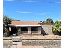 Charming single-story brick home with a red tile roof and covered front porch at 4004 W Westcott Dr, Glendale, AZ 85308