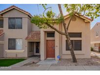 Inviting two-story townhome with a red tile roof and mature tree in front of the entrance at 500 N Roosevelt Ave # 118, Chandler, AZ 85226