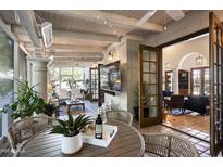 Inviting screened-in porch living space with wood ceiling, tile floor, and a view through open doors at 6221 E Vista Dr, Paradise Valley, AZ 85253