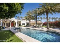 Beautiful backyard pool area with palm trees and a view of the stunning home exterior at 6221 E Vista Dr, Paradise Valley, AZ 85253