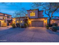 Charming two-story stucco home featuring a two-car garage and a tile roof at twilight at 7442 E Golden Eagle Cir, Gold Canyon, AZ 85118