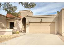 Charming home featuring a two-car garage and a distinctive red tile roof detail over the entryway at 10236 E Minnesota Ave, Sun Lakes, AZ 85248