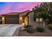 Charming home with a desert landscape, stone accents, and a tile roof at 13155 W Duane Ln, Peoria, AZ 85383