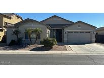 Charming single-story home with a well-manicured front yard and attached two-car garage at 13615 W Merrell St, Avondale, AZ 85392