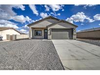 Charming single-story home featuring a two-car garage and low-maintenance gravel landscaping at 14951 S Capistrano Rd, Arizona City, AZ 85123