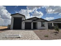 Charming single-story home featuring a two-car garage and inviting desert landscaping at 15765 W Cheryl Dr, Waddell, AZ 85355