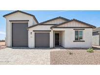 Charming single-story home featuring a three-car garage and desert landscaping at 15765 W Cheryl Dr, Waddell, AZ 85355