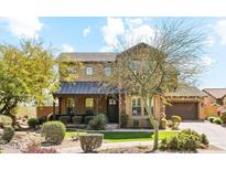 Charming two-story home with desert landscaping, covered porch, and a mix of stone and stucco facade at 17893 N 93Rd St, Scottsdale, AZ 85255