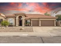 Charming single-story home with a well-manicured yard, three-car garage, and a beautiful tile roof at 3121 N Meadow Dr, Avondale, AZ 85392
