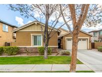 Charming single-story home featuring a two-car garage, desert landscaping, and a stone facade at 3567 E Sierra Madre Ave, Gilbert, AZ 85296