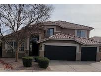 Two story home featuring an attached three car garage, neutral toned stucco exterior, and a clay tile roof at 361 E Pinto Ct, Gilbert, AZ 85296