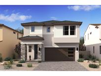 Inviting two-story home featuring stone accents, a modern garage door, and desert landscaping at 7970 W Griswold Rd, Peoria, AZ 85345