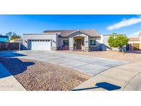 Charming single-story home with well-manicured front yard, desert landscaping and large driveway at 15802 N 50Th Dr, Glendale, AZ 85306