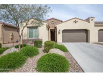 Charming single-story home featuring a well-manicured front yard with desert landscaping and a two-car garage at 16868 W Earll Dr, Goodyear, AZ 85395