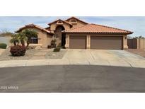 Charming two-story home with a three-car garage, red tile roof, and desert landscaping at 20997 N 96Th Ln, Peoria, AZ 85382