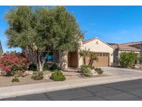 Attractive home exterior with desert landscaping and neutral color scheme at 26880 W Sierra Pinta Dr, Buckeye, AZ 85396