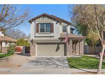Charming two-story home with a well-manicured lawn and a stone-accented facade at 4048 E Constitution Ct, Gilbert, AZ 85296