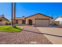 Charming single-story home featuring desert landscaping, a two-car garage and neutral toned exterior paint at 5123 E Beck Ln, Scottsdale, AZ 85254