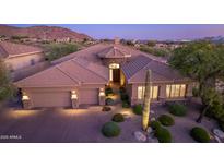 Stunning desert home with a tile roof, 3-car garage, and professionaly manicured desert landscaping at 10999 E Acoma Dr, Scottsdale, AZ 85255