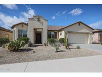 Charming single-story home featuring desert landscaping, a two-car garage, and a welcoming front entry at 16712 S 175Th Ln, Goodyear, AZ 85338