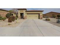 Charming single-story home with a spacious driveway and low-maintenance desert landscaping at 17662 W Cedarwood Ln, Goodyear, AZ 85338