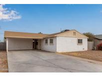 Charming single-story home featuring a covered carport and a well-maintained front yard at 2720 E Wier Ave, Phoenix, AZ 85040