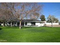 Charming single story home with mature trees and lush green lawn in a quiet neighborhood at 320 E Marlette Ave, Phoenix, AZ 85012