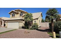 Charming two-story home with a well-maintained front yard and attached two-car garage at 524 W Naranja Ave, Mesa, AZ 85210