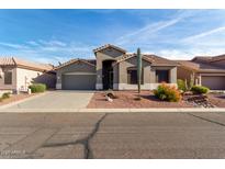 Charming single-story home with desert landscaping and a two-car garage at 5553 S Marble Dr, Gold Canyon, AZ 85118