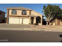 Charming two-story home featuring a well-manicured front yard and a three car garage at 6416 N 78Th Ln, Glendale, AZ 85303