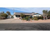 Charming home features solar panels, well-kept landscaping, and a spacious driveway at 1116 E 11Th E St, Casa Grande, AZ 85122