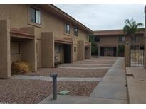 Cozy two-story apartment building with desert landscaping and neutral color scheme at 12627 N La Montana Dr # 104, Fountain Hills, AZ 85268