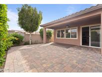 Open backyard featuring a covered patio, well maintained landscaping, and paver patio at 13110 W Avenida Del Rey --, Peoria, AZ 85383
