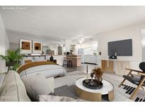 Staged open concept living area features a dining bar, kitchen, and relaxing furniture at 13232 N 98Th Ave # K, Sun City, AZ 85351