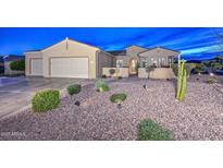 Charming single-story home with a well-maintained yard, desert landscaping, and a spacious two-car garage at 15004 W Home Run Dr, Surprise, AZ 85374