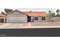 Charming single-story home with desert landscaping, a tile roof, and a two-car garage at 15018 S 28Th St, Phoenix, AZ 85048