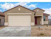 Inviting single-story home showcasing a neutral color palette, a two-car garage, and well-maintained landscaping at 17081 W Seldon Ln, Waddell, AZ 85355