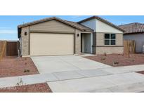 Charming single-story home featuring a two car garage and low maintenance desert landscaping at 17322 W Via Dona Rd, Surprise, AZ 85387