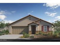Charming single-story home featuring a tan stucco exterior, two-car garage and desert landscaping at 17619 W Oberlin Way, Surprise, AZ 85387