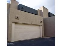 Exterior view of the home featuring a one car garage with a modern design and well-maintained facade at 3030 N Hayden Rd # 28, Scottsdale, AZ 85251