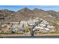 Scenic aerial view of a mountainside community boasting Southwestern architecture and desert landscaping at 3800 E Lincoln Dr # 7, Phoenix, AZ 85018